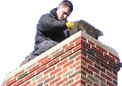 Travis Goss installs a chimney cover